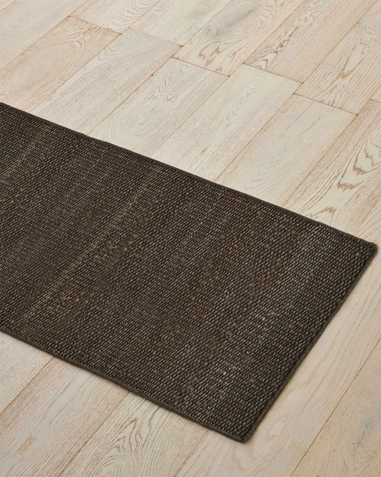 Ivano Graphite jute door mat, 65x120cm, close-up of hand-woven texture and rich chocolate-brown weave by Weave Home