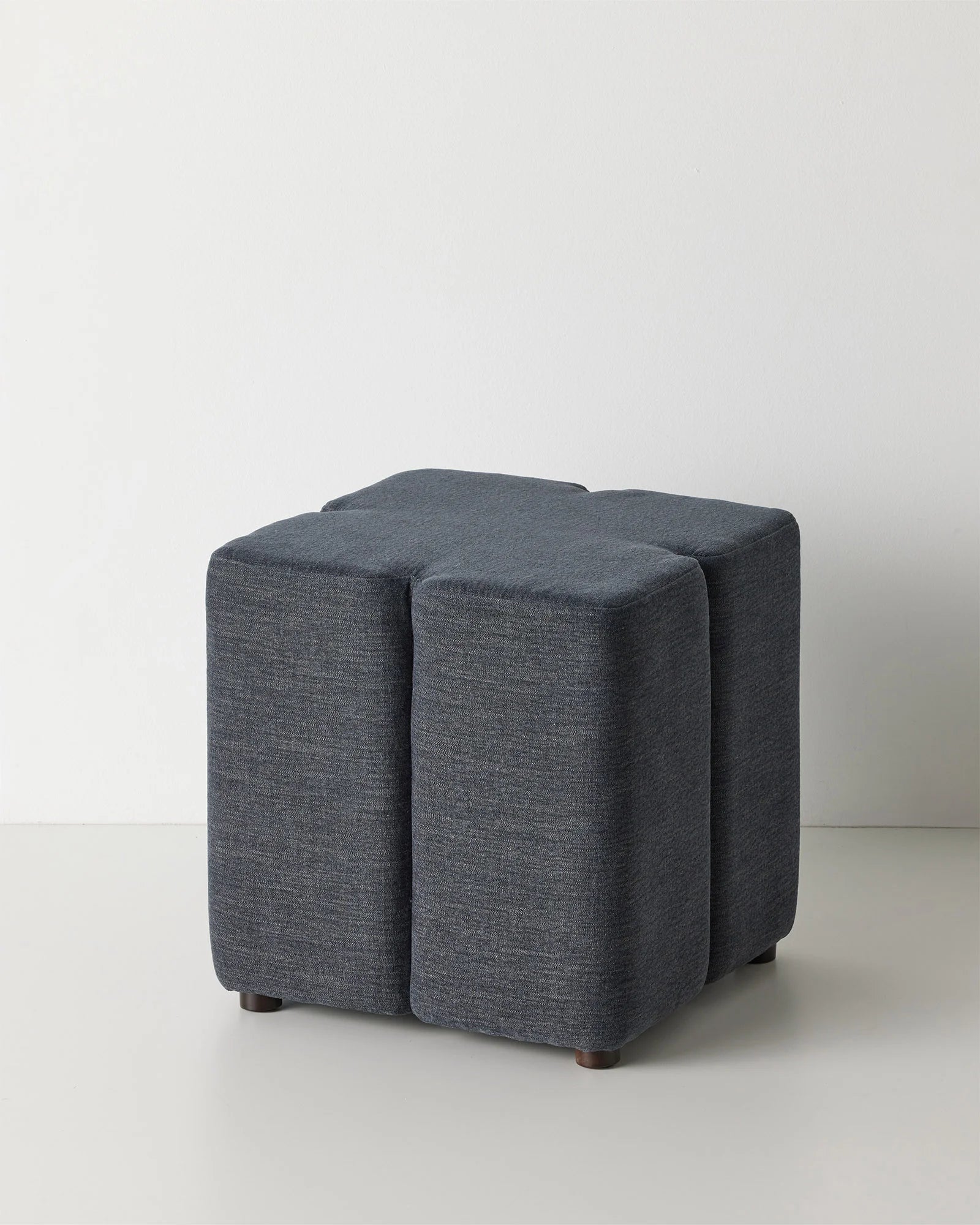 Campello Ocean ottoman in deep navy, front view, micro chenille upholstery with clover silhouette by Weave Home