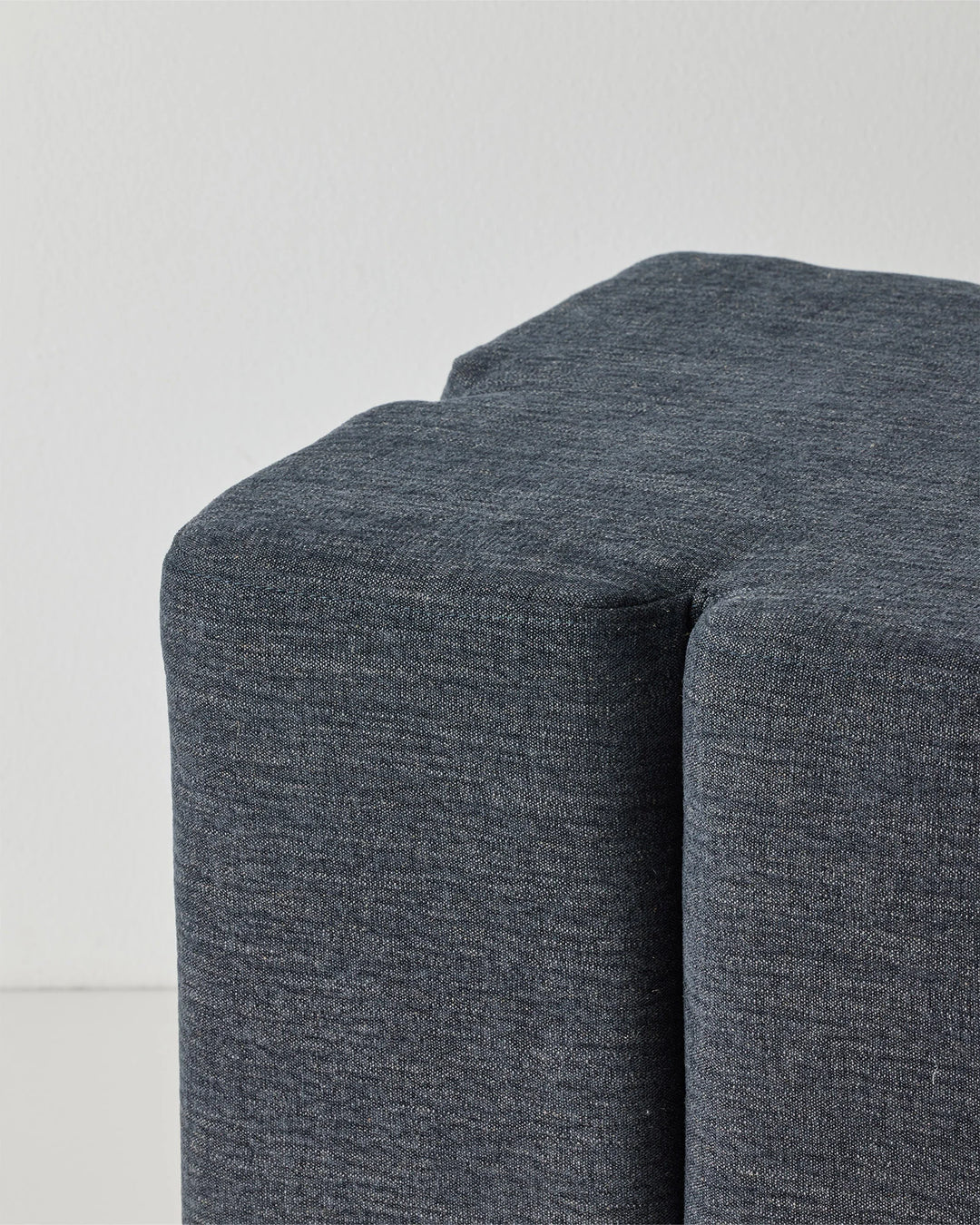 Campello Ocean ottoman, charcoal-blue micro chenille with clover-shaped silhouette and rounded edges, by Weave Home