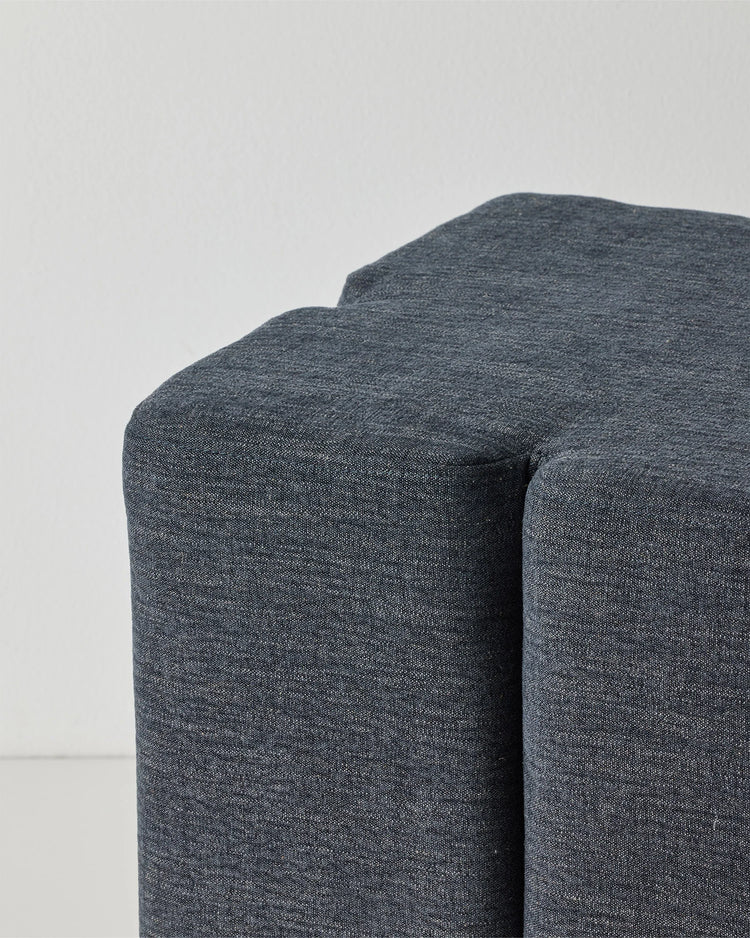 Campello Ocean ottoman, charcoal-blue micro chenille with clover-shaped silhouette and rounded edges, by Weave Home