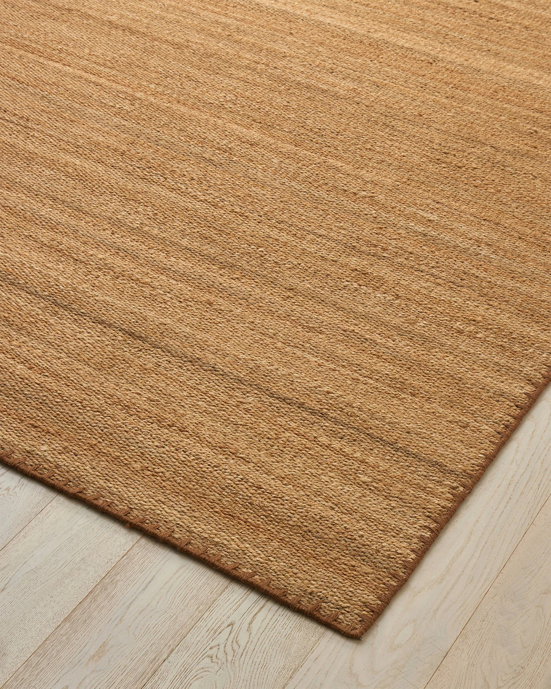 Monroe Biscuit high-traffic rug in warm golden neutral with blanket stitch border detail, by Weave Home