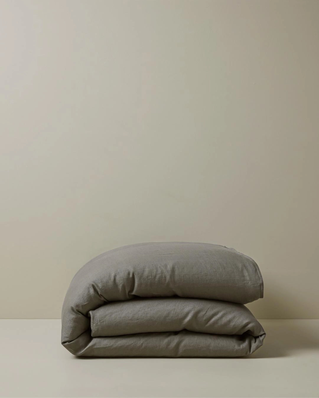 Ravello Quilt Cover in charcoal European linen, folded to show soft texture and relaxed drape, by Weave Home
