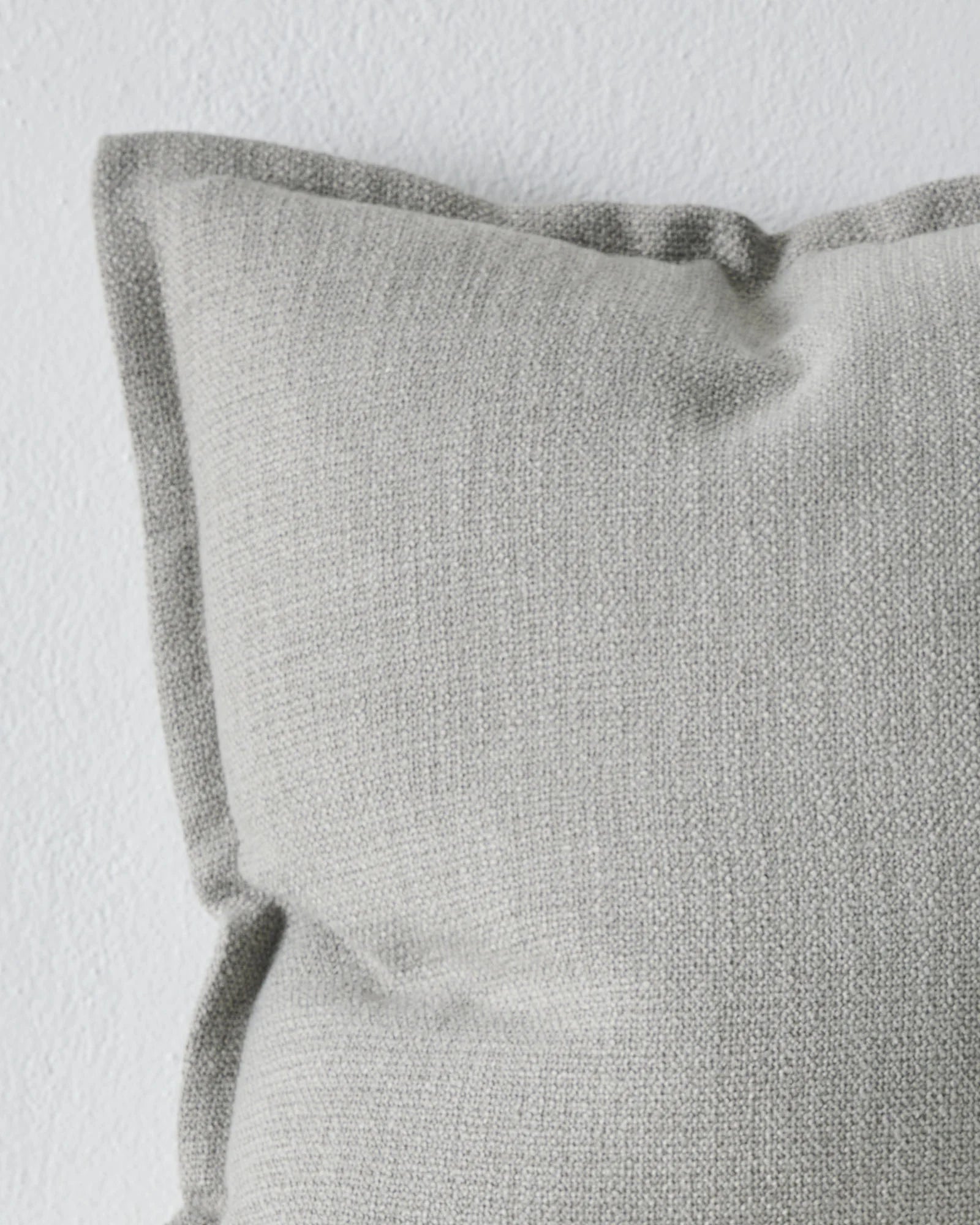 Figlio Mineral 50x50 cushion cover, close-up of soft grey woven polyester with rolled edge detail by Weave Home