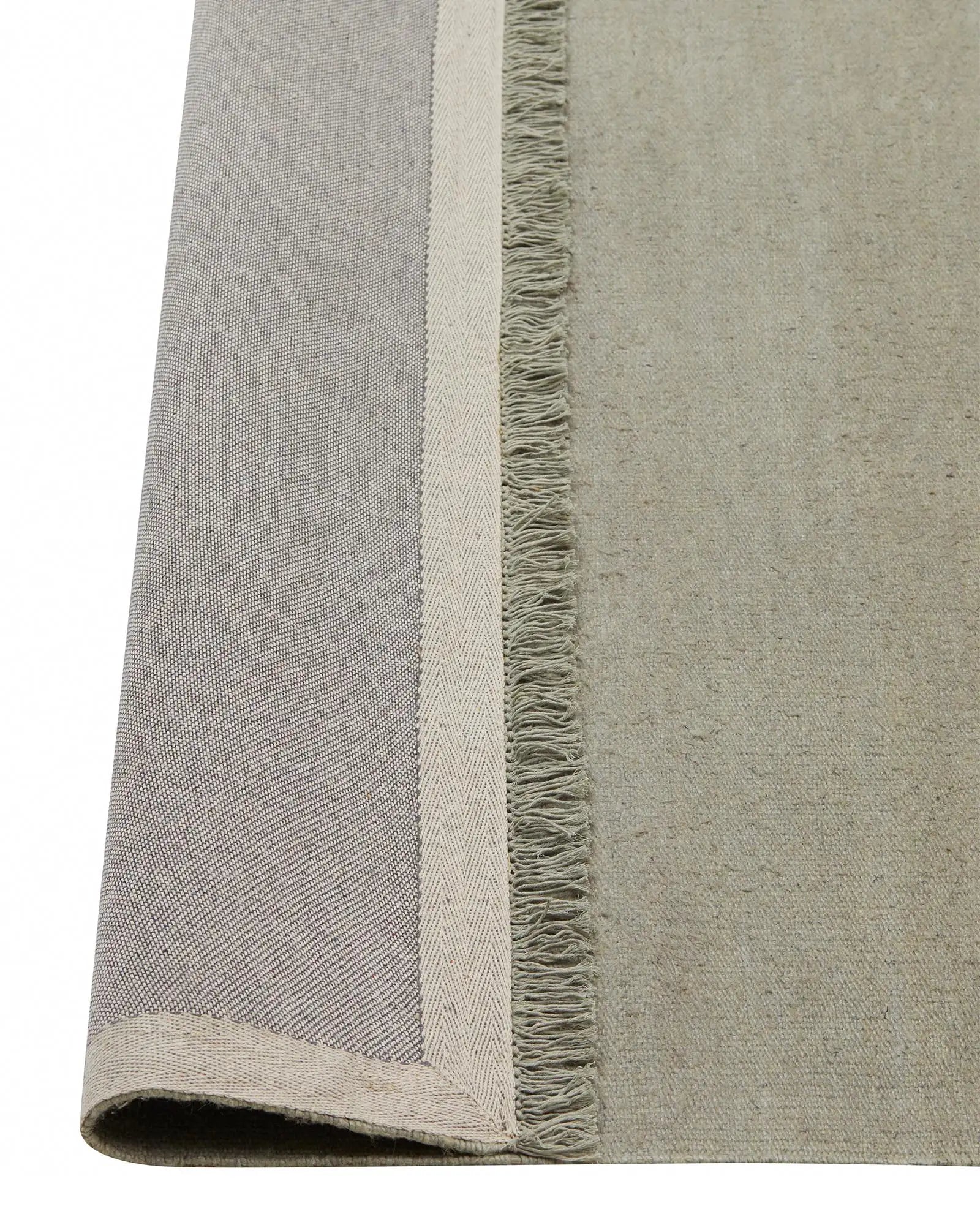 Emilio Flint linen rug detail showing flat-weave texture and fringe border edge by Weave Home