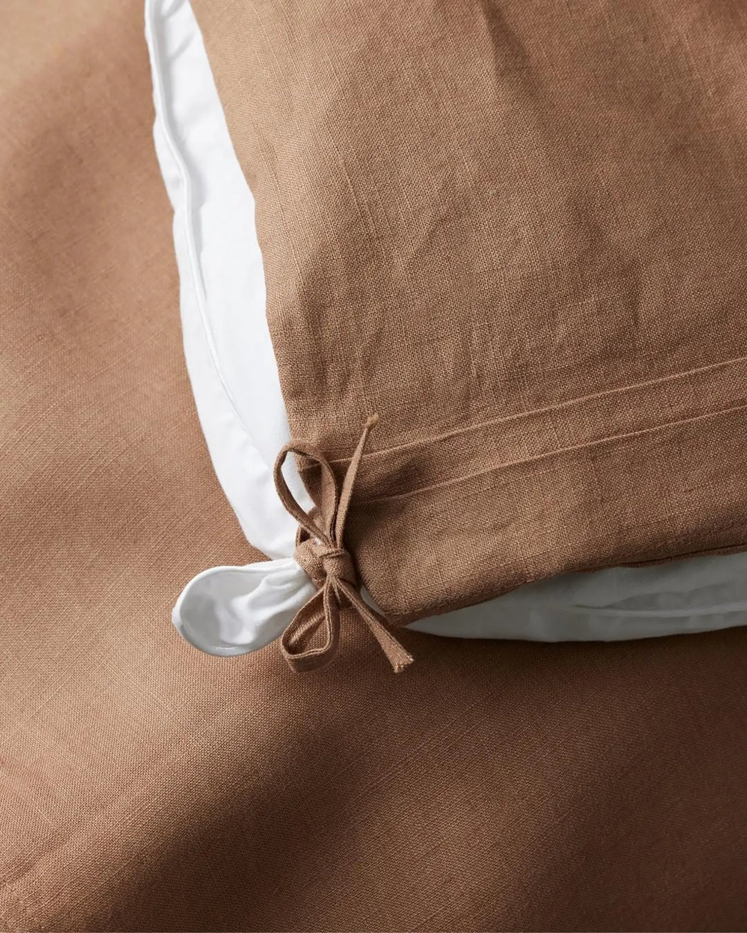 Ravello Quilt Cover in biscuit, detail shot showing internal tie closure and white piping edge by Weave Home