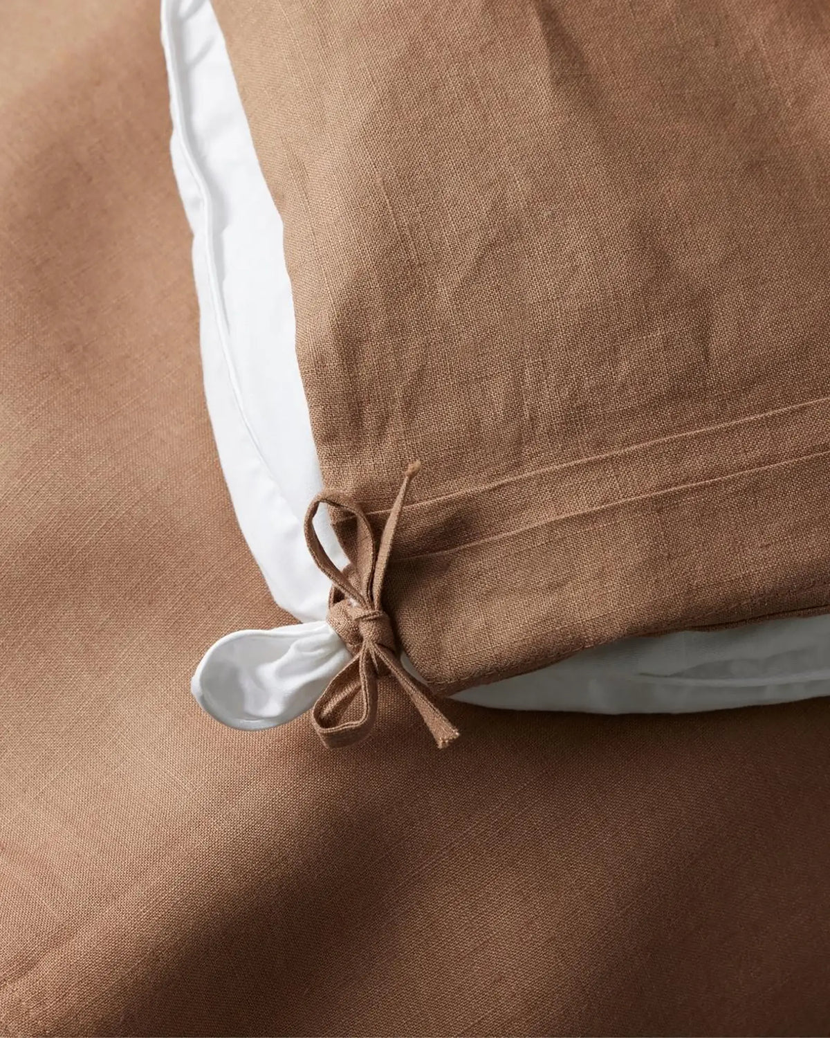 Ravello Quilt Cover in biscuit, detail shot showing internal tie closure and white piping edge by Weave Home