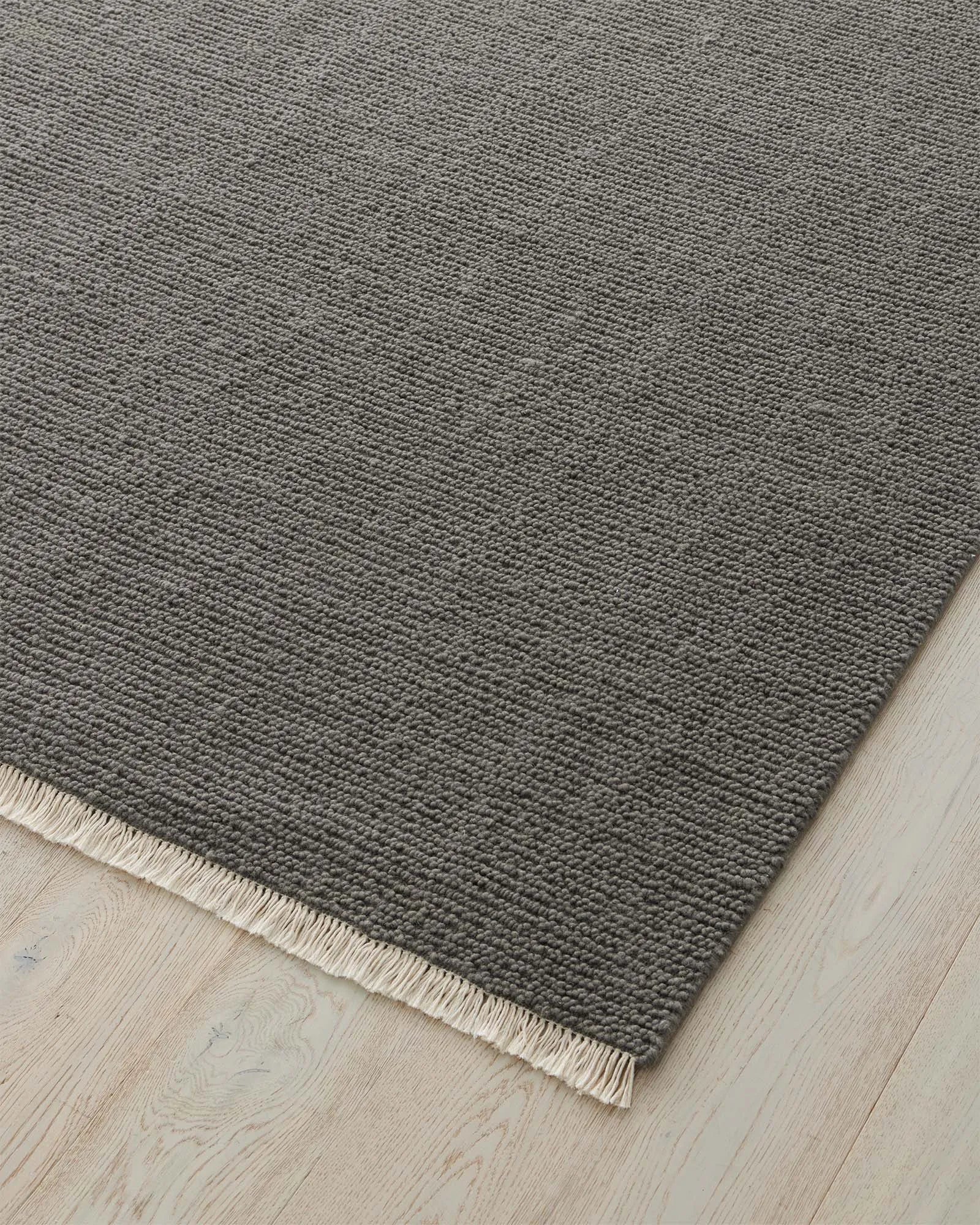 Fabien Echo textured wool rug in medium grey, close-up showing chunky ribbed weave and cream fringe border by Weave Home
